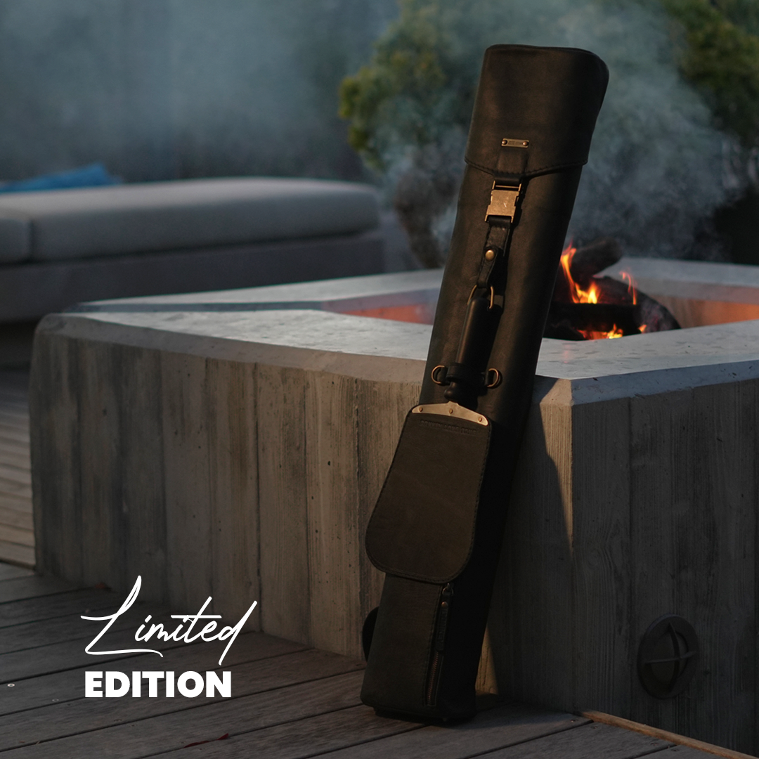 The limited edition Black Sack leaning on a sleek, high build fire place.
